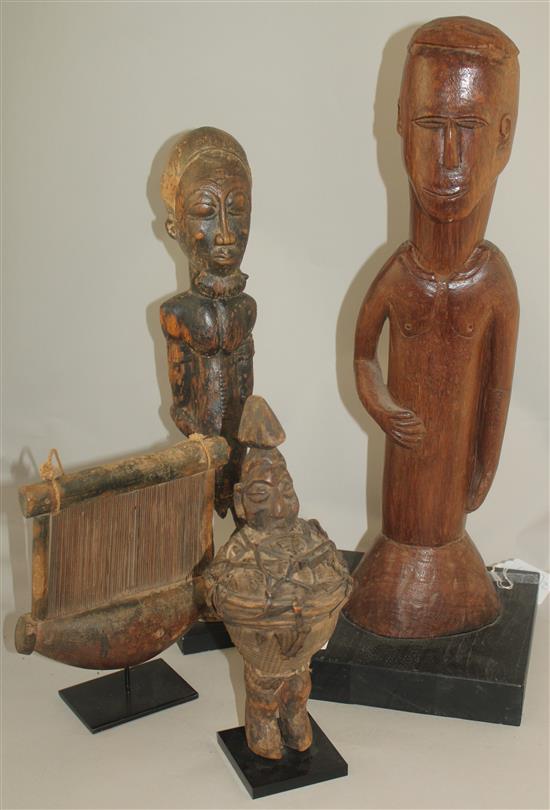 An African Ivory Coast Baule figure of a standing male, largest figure 20.5in.